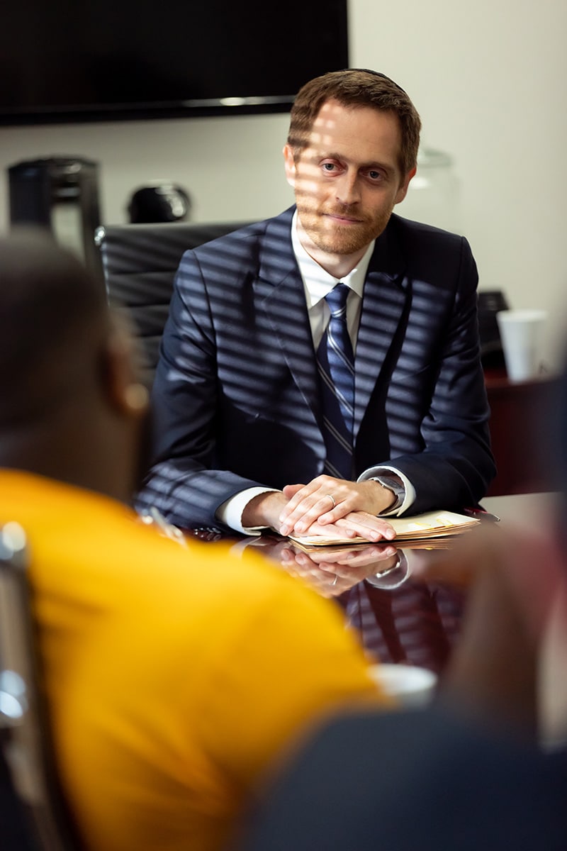 an experienced criminal defense attorney sitting down with client.
