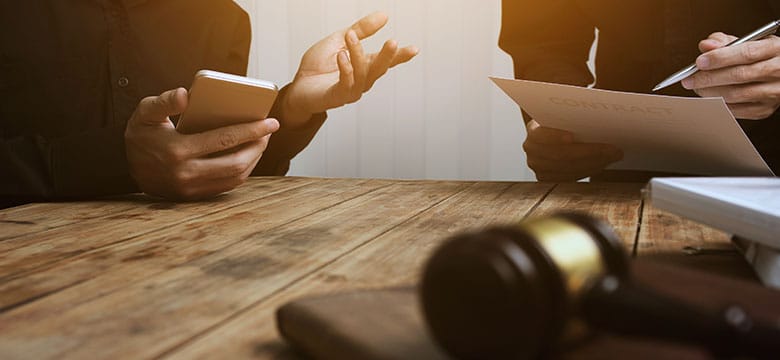 Hands of attorney and client as they discuss inadmissible evidence