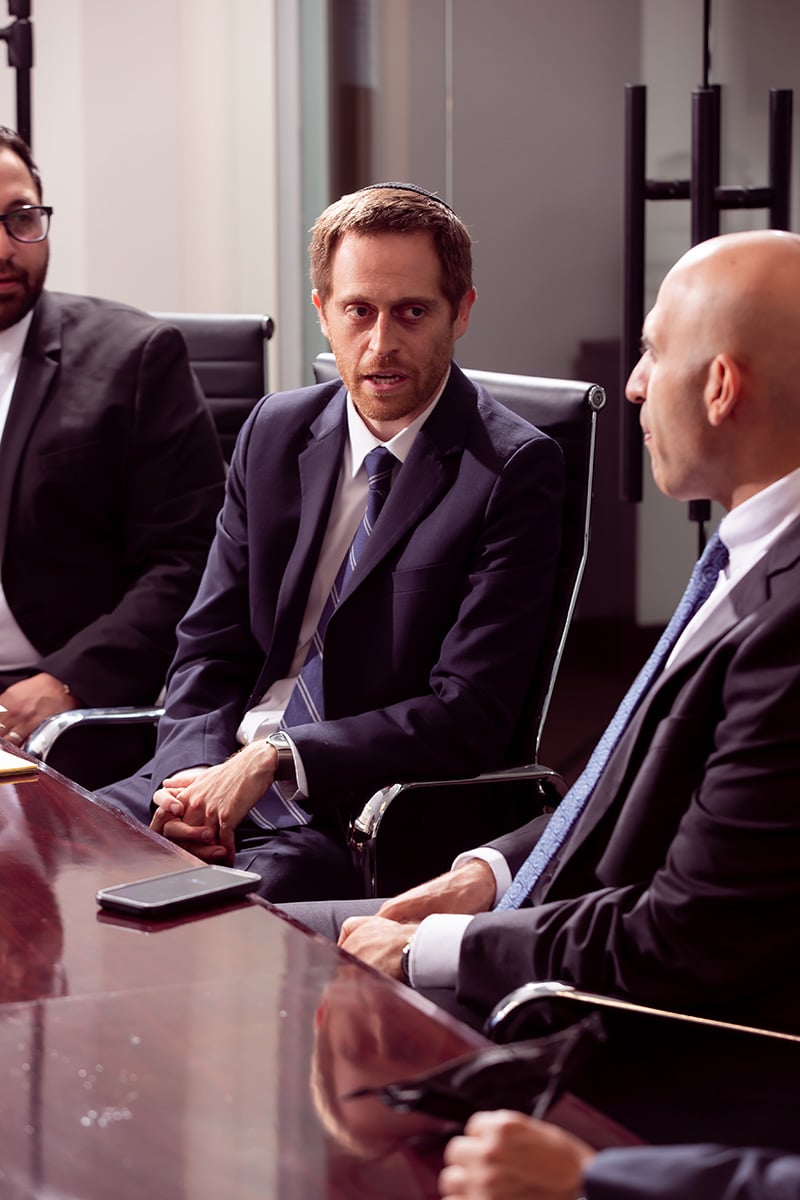 Attorney Aaron Spolin discussing with other members of the legal team